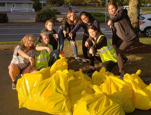 youth in front of bagged trash
